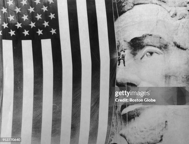 Bob Crisman attaches a flag to Lincoln for the Mount Rushmore National Park Fourth of July ceremony in Keystone, S.D., July 4, 1987. The 50th...