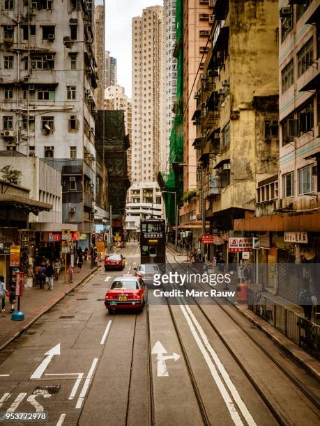 street photo from hong kong, showing the hong kong tramways "ding ding" - rauw stock pictures, royalty-free photos & images