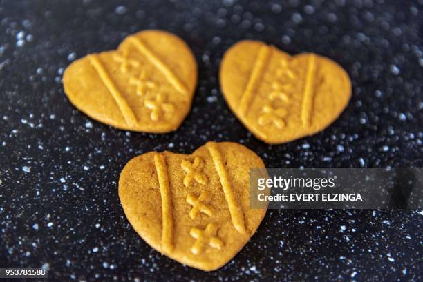 This photograph taken on May 2 shows 'Eberhardje' biscuits or cookies on display in Amsterdam. - The heart-shaped cookie with the logo of the city is...