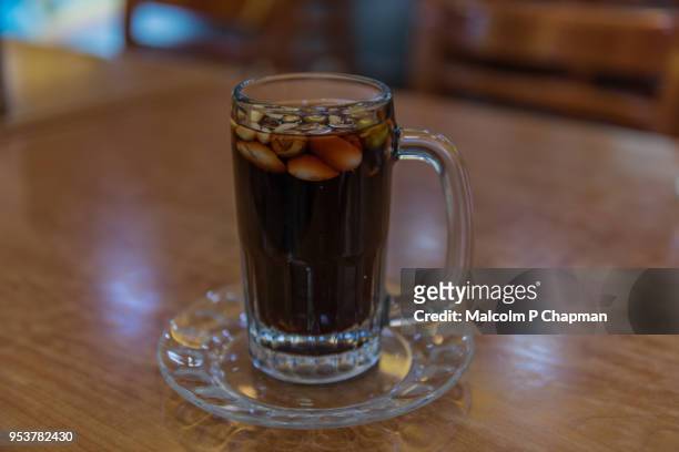 jallab - date juice with carob, grape juice and rose water. this popular middle east drink is served with pine nuts, almonds and pistachios. - p nut fotografías e imágenes de stock