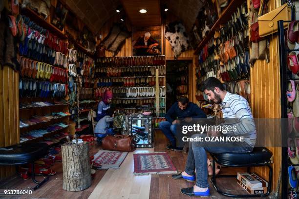 Traditional shoe makers work in their workshop, in the historical part of Gaziantep city, on May 2 southeastern Turkey.