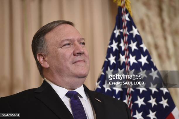Mike Pompeo looks on as US President Donald Trump speaks during the ceremonial swearing-in of US Secretary of State Mike Pompeo at the State...