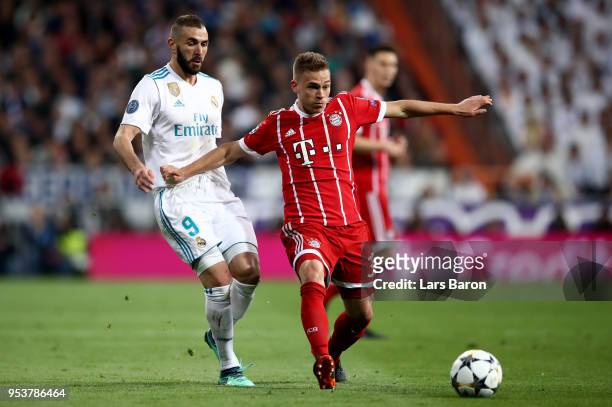 Karim Benzema of Madrid challanges Joshua Kimmich of Muenchen during the UEFA Champions League Semi Final Second Leg match between Real Madrid and...