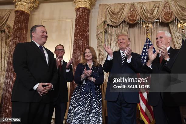 President Donald Trump applauds after Mike Pompeo took the oath during his ceremonial swearing-in as US Secretary of State, along with Susan Pompeo,...