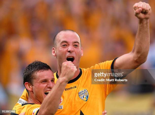 Kristian Rees and Jason Culina of United celebrate a goal during the round 21 A-League match between Gold Coast United and Brisbane Roar at Skilled...