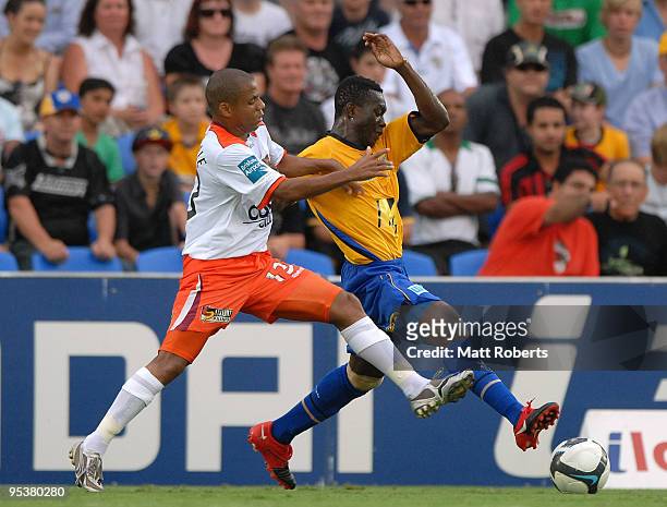 Henrique of Roar contests the ball with Adama Traore during the round 21 A-League match between Gold Coast United and Brisbane Roar at Skilled Park...