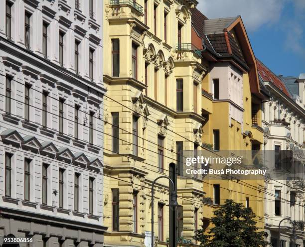 facades of beautifully renovated old buildings in the kastanienallee in berlin (germany), district of prenzlauer berg - prenzlauer berg stock pictures, royalty-free photos & images