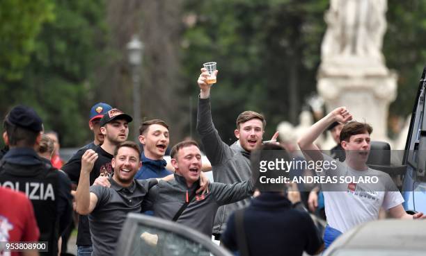 Liverpool supporters chant as they are watched by policemen in Rome on May 2 ahead of the Champions League semi-final football match AS Roma vs...