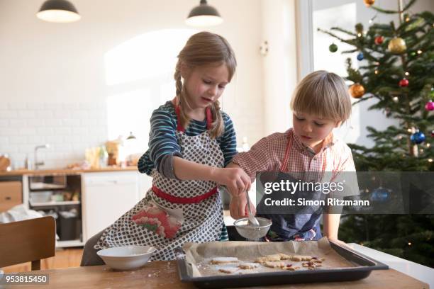sister and brother making cookies at christmas - kids advent stock pictures, royalty-free photos & images