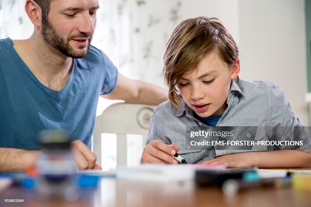 Private tutoring lesson for 10 years old blonde elementary school boy while doing his homework together with male tutor in his thirties.