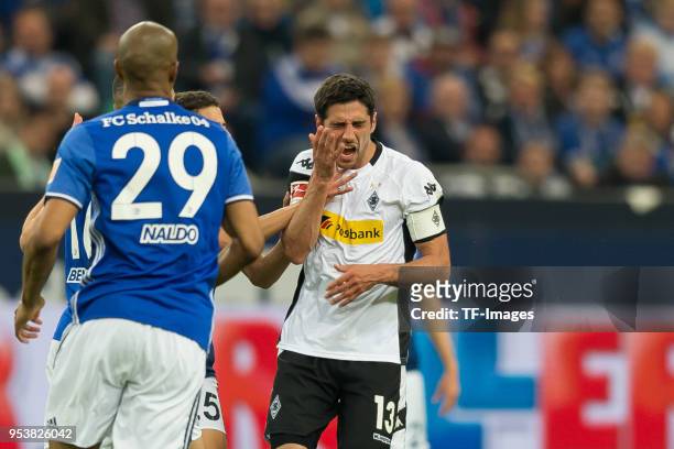 Amine Harit of Schalke attackes Lars Stindl of Moenchengladbach during the Bundesliga match between FC Schalke 04 and Borussia Moenchengladbach at...
