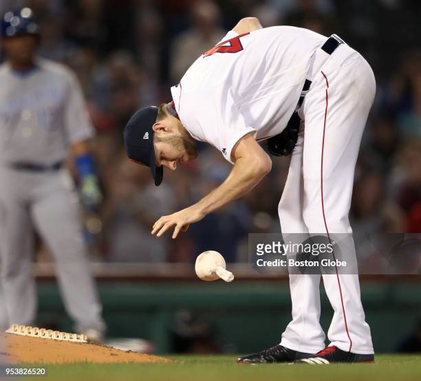 Boston Red Sox starting pitcher Chris Sale picks up and then slams the rosin bag to the ground after he hit the Royals' Lucas Duda with a pitch in...