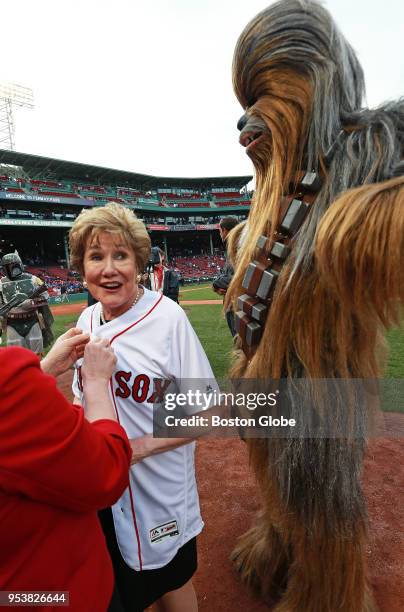Former U.S. Senator Elizabeth Dole stands with an actor dressed as Star Wars character Chewbacca before Veteran Caregiver Jason Courneen threw out a...