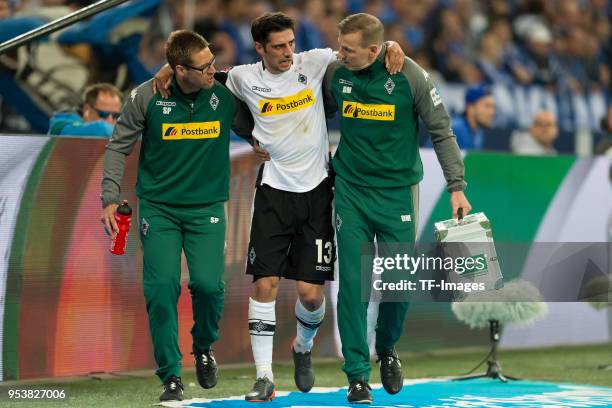 Lars Stindl of Moenchengladbach leaves the field injured during the Bundesliga match between FC Schalke 04 and Borussia Moenchengladbach at...