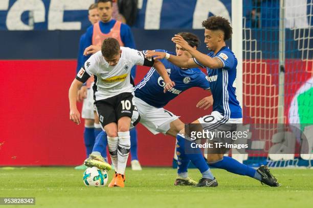 Thorgan Hazard of Moenchengladbach, Benjamin Stambouli of Schalke and Thilo Kehrer of Schalke battle for the ball during the Bundesliga match between...