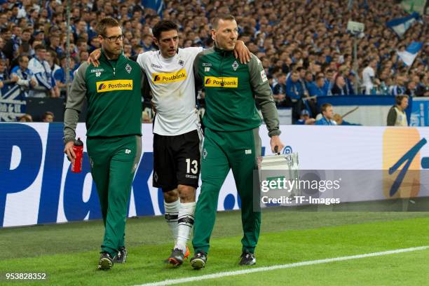 Lars Stindl of Moenchengladbach leaves the field injured during the Bundesliga match between FC Schalke 04 and Borussia Moenchengladbach at...