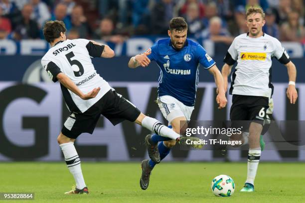 Tobias Strobl of Moenchengladbach and Daniel Caligiuri of Schalke battle for the ball during the Bundesliga match between FC Schalke 04 and Borussia...