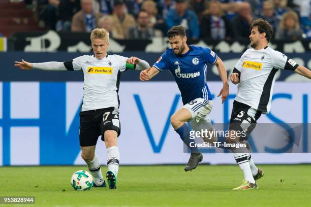Oscar Wendt of Moenchengladbach, Daniel Caligiuri of Schalke and Tobias Strobl of Moenchengladbach battle for the ball during the Bundesliga match...
