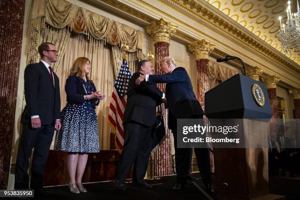 President Donald Trump, right, shakes hands with Mike Pompeo, U.S. Secretary of state, before being sworn in during a ceremony with Susan Pomepo,...