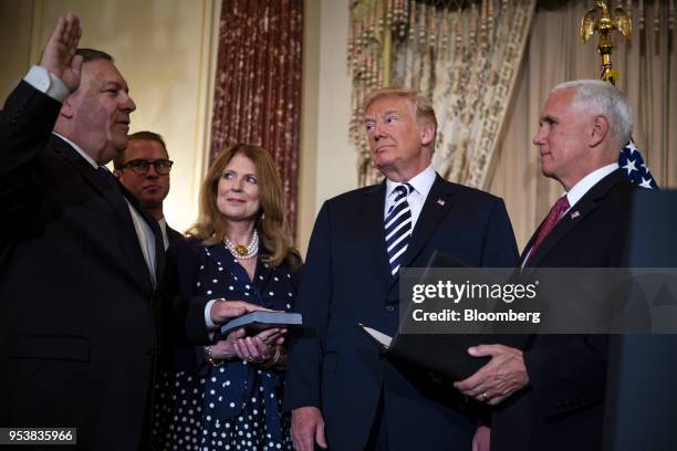 Mike Pompeo, U.S. Secretary of state, left, is sworn in by U.S. Vice President Mike Pence, right, with U.S. President Donald Trump, center, Susan...