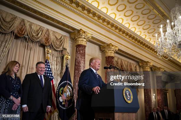 President Donald Trump, right, speaks before Mike Pompeo, U.S. Secretary of state, second left, is sworn in during a ceremony with Susan Pomepo,...