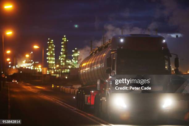 truck carrying oil leaving refinery - oil tanker stock pictures, royalty-free photos & images