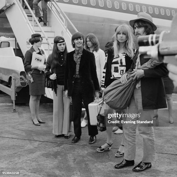 English drummer Ringo Starr with his wife Maureen Cox and English guitarist George Harrison with his wife Pattie Boyd at Heathrow Airport, London,...