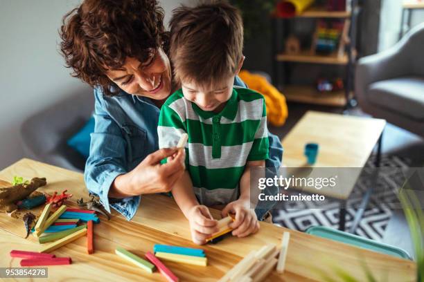 cute little boy and his mother - block removal game stock pictures, royalty-free photos & images