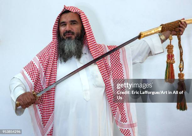 Portrait of an old saudi man with a sword, Al-Jawf Province, Sakaka, Saudi Arabia on January 17, 2010 in Sakaka, Saudi Arabia.