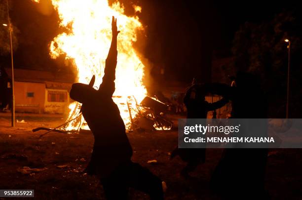 Ultra-Orthodox Jew dance around a bonfire in Jerusalem's Ultra-Orthodox Mea Shearim neighbourhood on May 2 during celebrations for the Jewish holiday...