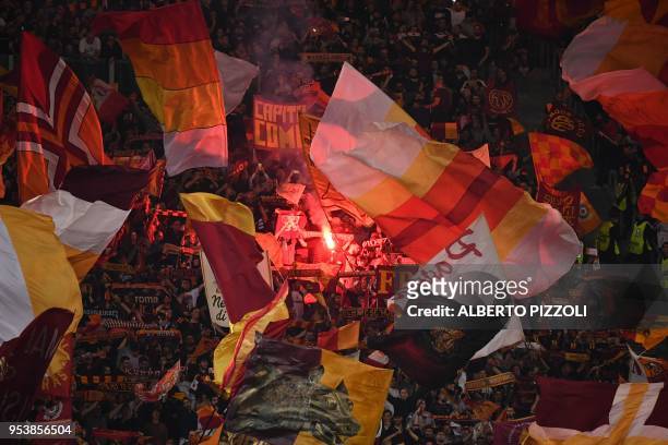 Roma's fans light a flare in the grandstand before the UEFA Champions League semi-final second leg football match AS Roma vs Liverpool FC at the...