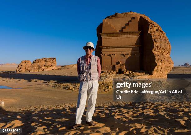 Japanese tourist in front of qsar farid nabataean tomb in madain saleh archaeologic site, Al Madinah Province, Al-Ula, Saudi Arabia on January 23,...