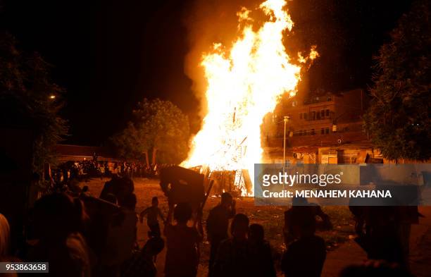 Ultra-Orthodox Jew dance around a bonfire in Jerusalem's Ultra-Orthodox Mea Shearim neighbourhood on May 2 during celebrations for the Jewish holiday...