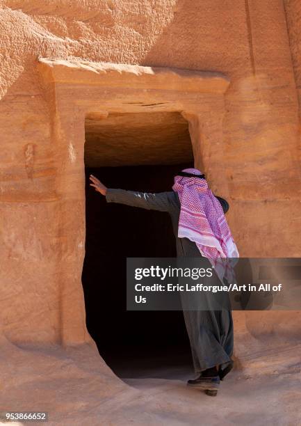 Saudi tourist visiting a nabataean tomb in madain saleh archaeologic site, Al Madinah Province, Al-Ula, Saudi Arabia on January 25, 2010 in Al-ula,...