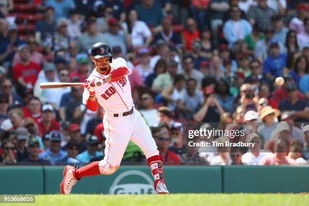 Mookie Betts of the Boston Red Sox hits a solo home run during the seventh inning against the Kansas City Royals at Fenway Park on May 2, 2018 in...