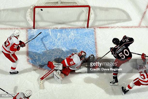 Antoine Vermette of the Columbus Blue Jackets scores on Jimmy Howard of the Detroit Red Wings as teammates Doug Janik and Valtteri Filppula watch the...