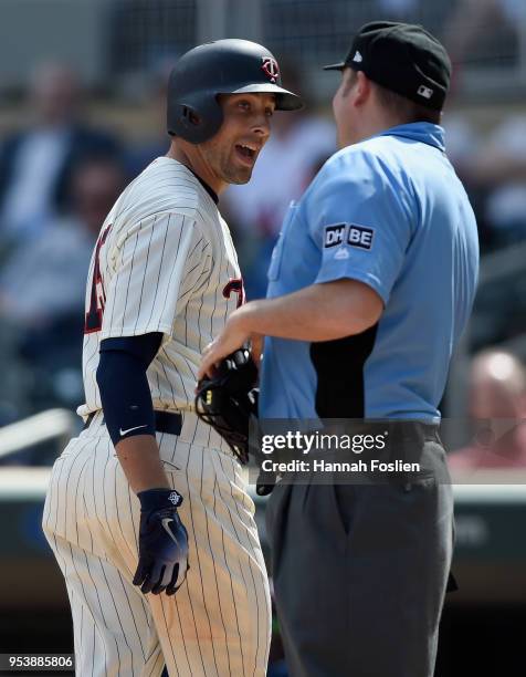 Jason Castro of the Minnesota Twins speaks to home plate umpire Dan Bellino after striking out against the Toronto Blue Jays during the ninth inning...