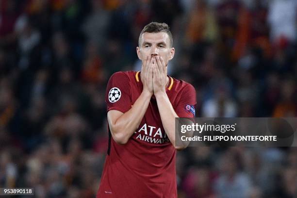 Roma's Bosnian striker Edin Dzeko reacts after missing a goal opportunity during the UEFA Champions League semi-final second leg football match...