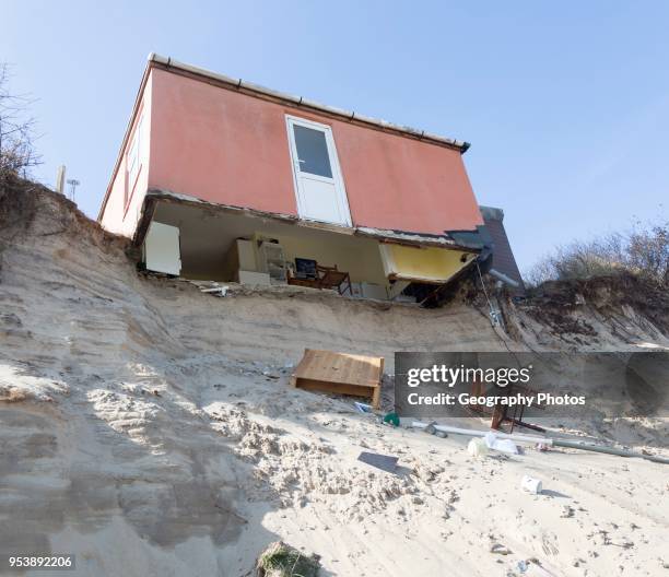 March 2018, Clifftop property collapsing due to coastal erosion after recent storm force winds, Hemsby, Norfolk, England, UK.