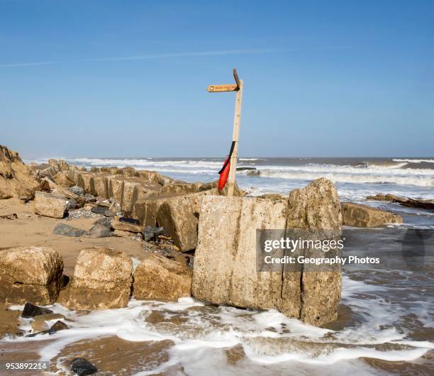 March 20 2018 Hemsby, UK. Coast path sign left abandoned by coastal erosion at Hemsby, Norfolk, England, UK.