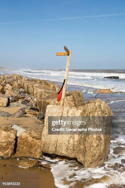 March 20 2018 Hemsby, UK. Coast path sign left abandoned by coastal erosion at Hemsby, Norfolk, England, UK.