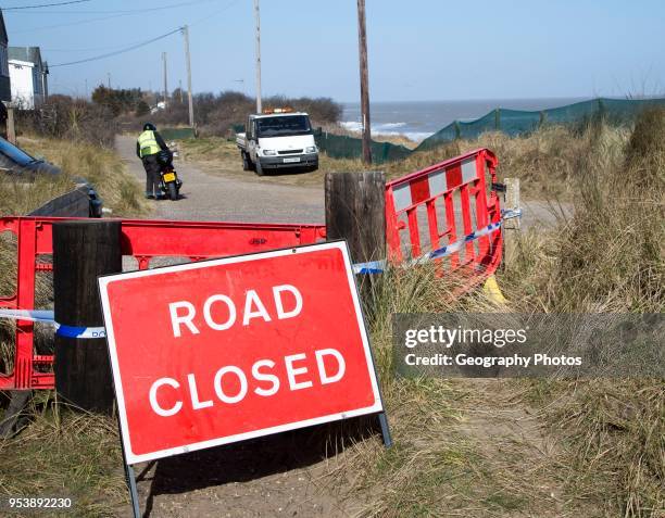 March 2018, Clifftop property collapsing due to coastal erosion after recent storm force winds, Hemsby, Norfolk, England, UK Road Closed sign.