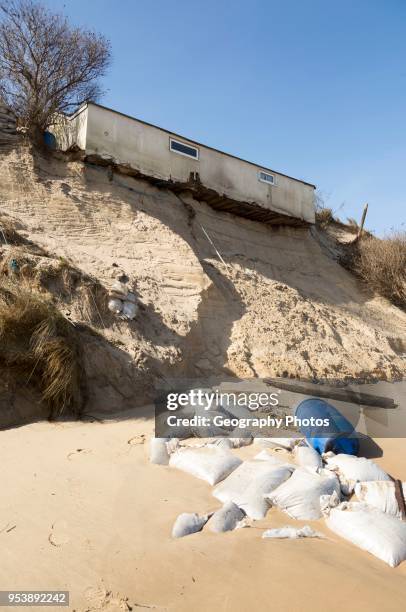 March 2018, Clifftop property collapsing due to coastal erosion after recent storm force winds, Hemsby, Norfolk, England, UK.