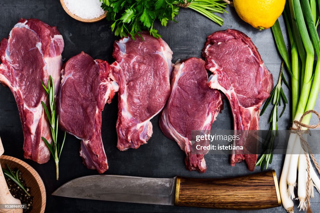 Fresh raw uncooked veal steaks with ingredients