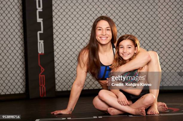 Portrait of bantamweight MMA fighter and former Olympic wrestler Sara McMann posing with her daughter Bella in octagon during photo shoot at Team...