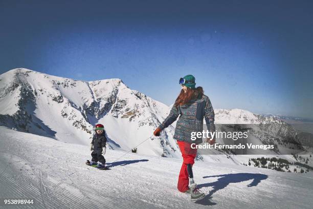 Portrait of USA Olympic snowboarder Brenna Huckaby with her daughter Lilah during photo shoot at Snowbird Ski and Summer Resort in the Wasatch Range...