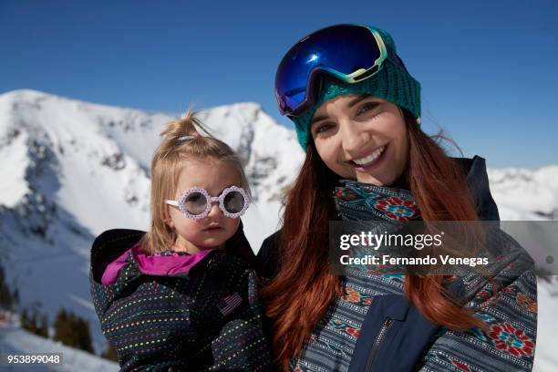 Portrait of USA Olympic snowboarder Brenna Huckaby with her daughter Lilah during photo shoot at Snowbird Ski and Summer Resort in the Wasatch Range...