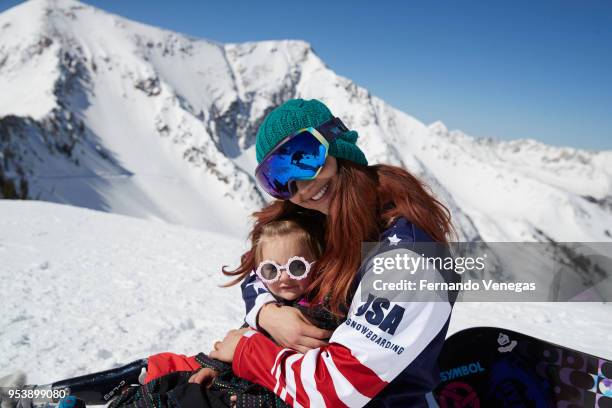 Portrait of USA Olympic snowboarder Brenna Huckaby with her daughter Lilah during photo shoot at Snowbird Ski and Summer Resort in the Wasatch Range...