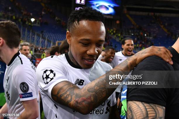Liverpool's English defender Nathaniel Clyne celebrates their victory at the end of the UEFA Champions League semi-final second leg football match AS...