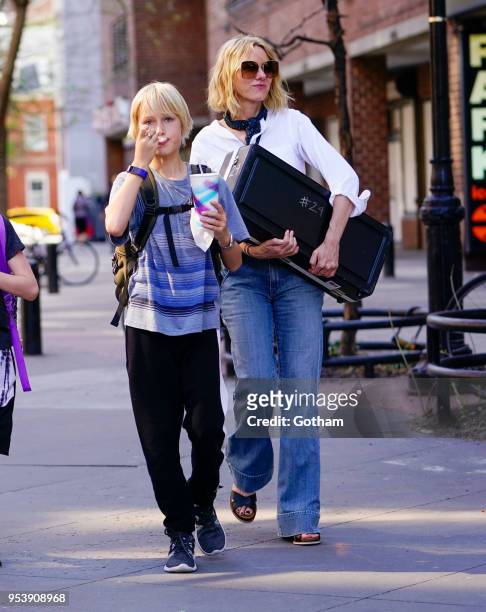 Naomi Watts holds a musical instrument when walking to school with Alexander Schreiber on May 2, 2018 in New York City.